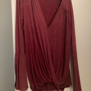 Bell sleeves  that slit open. Size S but fits like a M.